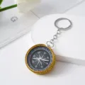 Detailed close-up view of a gold rhinestone-studded compass keychain for outdoor navigation - Yellow