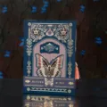 Detail view of the gothic retro butterfly notebook with gold foil and tassel accent. - Style C (Blue)
