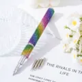 Close-up of a rainbow rhinestone nail art pen with five interchangeable metal tips - Colorful