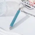Macro detail view of a sparkling blue rhinestone-studded dual-ended nail art dotting pen - Sky Blue