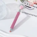 Close-up detail of a pink rhinestone encrusted dual-ended nail art dotting tool - Pink