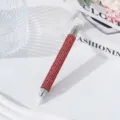 Close-up of dual-ended nail art dotting pen with red rhinestone barrel - Red