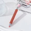Detail shot of an orange rhinestone-encrusted nail art dotting pen tool. - Orange Red