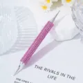 Macro view of pink rhinestone-encrusted nail art dotting tool with dual tips - Pink