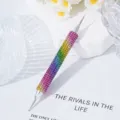 Detailed macro view of a double-ended rainbow rhinestone nail art dotting tool for manicure - Colorful