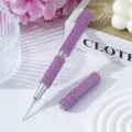 Detailed macro view of a purple rhinestone nail art dotting pen with a fine metal needle tip - Light Purple