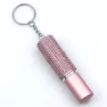Close-up view of pink rhinestone-studded 5ml refillable perfume spray bottle keychain. - Pink Bottle with Pink Rhinestones