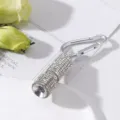 Detail of mini LED flashlight decorated with rhinestones and metal carabiner keychain - White