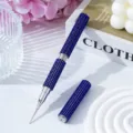 Close-up of a dual-ended nail art pen covered in luxurious blue rhinestones - Sapphire Blue