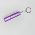 Detalle de un atomizador de perfume púrpura de 5ml con llavero metálico portátil - Púrpura
