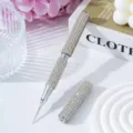 Close-up showing the sparkling silver rhinestone texture of a dual-ended nail art pen - White