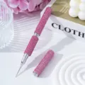 Detailed macro view of a pink rhinestone-studded dual-head nail art dotting pen - Pink