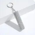 Detailed view of iridescent rhinestone-encrusted lipstick-shaped perfume atomizer keychain - 10ml / AB White