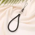 Close-up of a luxury black sparkling 6mm diamond-encrusted phone wrist lanyard strap. - Black