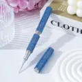 Detail view of double-ended nail art dotting pen covered in sparkling blue rhinestones - Blue