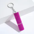 Detailed macro view of a sparkling pink rhinestone-studded perfume refill bottle keychain - Rose Red
