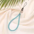 Close-up detail of 6mm blue rhinestone phone strap wristlet with a sparkling finish. - Cyan Blue