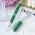 Detailed macro view of a luxury green rhinestone-encrusted dual-ended nail art dotting tool - Green