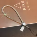 Macro view of luxury sparkling rhinestone phone wrist strap with gold bar charm - Gold Bar Tag Wrist Rope / Rainbow (Wrist Style)