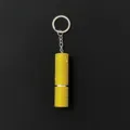 Close-up of portable 5ml perfume atomizer keychain covered in yellow rhinestones - Yellow