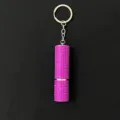 Detail view of pink rhinestone studded perfume atomizer bottle keychain accessory. - Rose Red