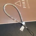 Detailed view of luxury full rhinestone phone wrist strap with embossed Queen charm - Queen Portrait Tag Wrist Rope / White/Silver (Wrist Style)