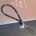 Detailed view of a luxury green rhinestone phone wrist strap with crystal charm. - Vintage Portrait Tag Wrist Rope / Deep Green (Wrist Style)