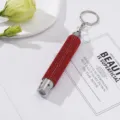 Detailed close-up of mini LED flashlight keychain with sparkling red rhinestones. - Without Battery / Red