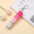 Primer plano de llavero frasco de perfume diamantes imitación rosa - Degradado Rosa