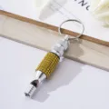 Detailed view of silver aluminum alloy survival whistle decorated with yellow rhinestones - Yellow