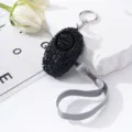 Detailed macro view of elegant black rhinestone personal security alarm for women protection. - Black
