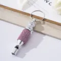 Detailed view of a silver aluminum survival whistle decorated with pink rhinestones - Pink