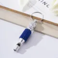 Detail view of survival whistle keychain with shiny blue rhinestones and silver metal finish - Sapphire Blue