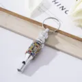 Close-up of a rhinestone aluminum whistle keychain for outdoor survival training - Colorful Zirconia