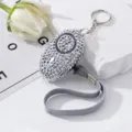 Detail view of a sparkly rhinestone personal safety alarm with keychain - Gray