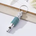 Close-up view of a diamond-encrusted aluminum alloy whistle featuring blue rhinestones - Lake Blue