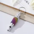 Detail view of rhinestone aluminum alloy whistle keychain with rainbow colors. - Colorful