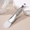 Close-up of rhinestone-encrusted double-ended silicone facial mask brush with scoop. - Silicone Brush / AB White