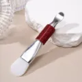 Detail of dual-ended silicone mask brush with red rhinestone handle and metal scoop. - Silicone Brush / Red