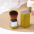 Close-up detail of luxury rhinestone-encrusted nail dust brush with gold crystals - Yellow (White Sole)