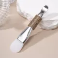 Detailed macro view of a double-ended silicone mask brush with a sparkling rhinestone handle - Silicone Brush / Khaki