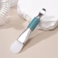 Macro detail of double-headed face mask brush with silicone tip and blue rhinestone handle - Silicone Brush / Lake Blue