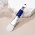 Detail of double-ended silicone mask brush with blue rhinestone handle and metal spatula. - Silicone Brush / Sapphire Blue