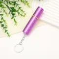 Detailed view of mini purple rhinestone perfume atomizer bottle with keychain attachment - Purple