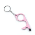 Detailed macro view of a pink zinc alloy no-touch door opener keychain with stylus tip - Pink