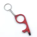 Close-up of a red zinc alloy EDC no-touch door opener keychain with a black stylus tip - Red