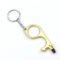Detail view of multifunctional zinc alloy no-touch door opener keychain with stylus tip - Gold