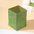 Detailed view of the sparkling green rhinestones on this luxury makeup brush holder - Green
