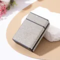 Close-up of a luxurious cigarette case fully covered with sparkling rhinestones. - White