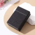 Detailed macro view of a luxury black rhinestone-encrusted cigarette storage case - Black